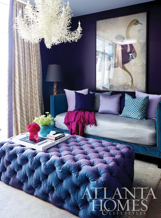 violet and teal glam living room with a unique chandelier and a crazy artwork