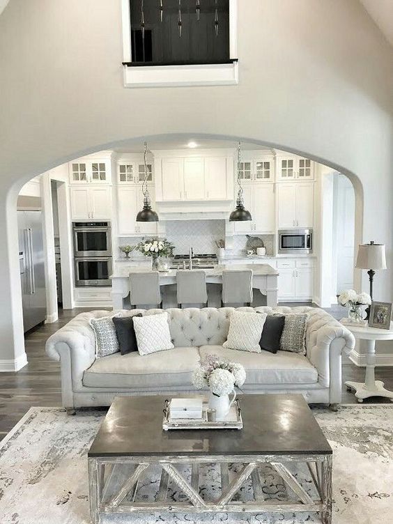 All white kitchen with greys and a grey and silver living room with an open plan
