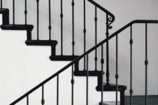 25 black and white space with a stylish staircase with black iron handrail and balustrade