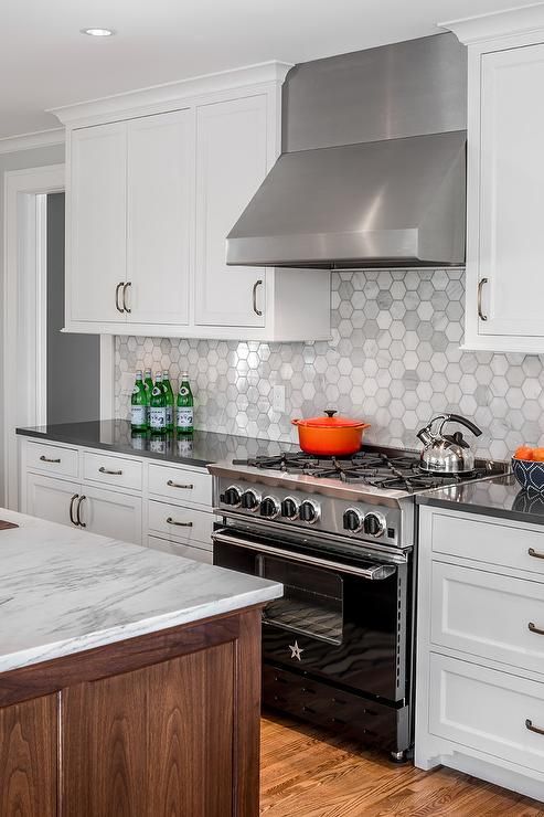 white cabinets accented with oil rubbed bronze pulls and a charcoal gray quartz countertop
