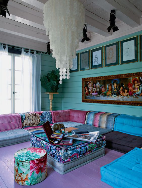 large boho chic living room with turquoise walls and colorful upholstery