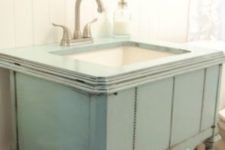 26 repurposed sewing machine cabinet was painted patina color and used as a vanity