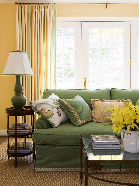 green upholstery and striped curtains with touches of orange, green and yellow