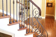 28 warm wood staircase and wrought iron balustrade of a lighter color to stand out