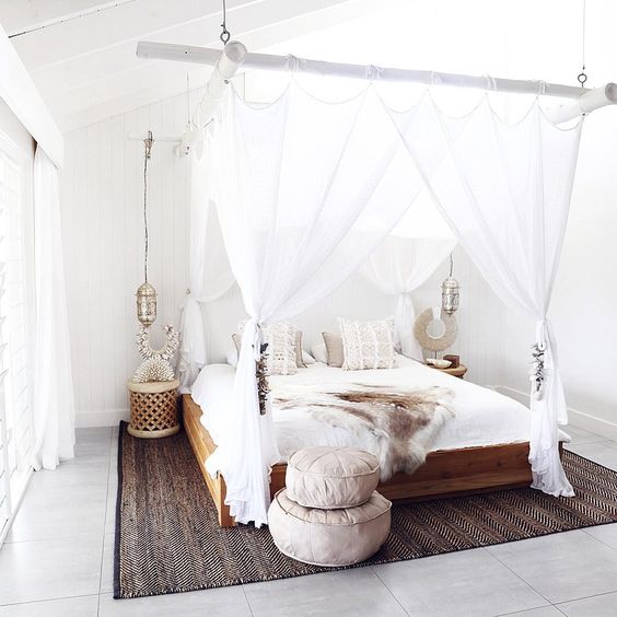 Boho chic inspired bedroom with a cool bamboo beams for hanging a canopy