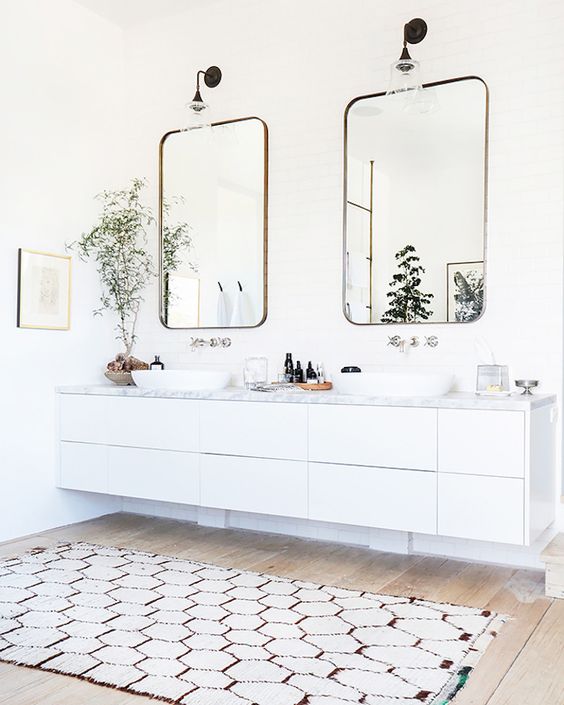 modern white floating vanity with a marble top