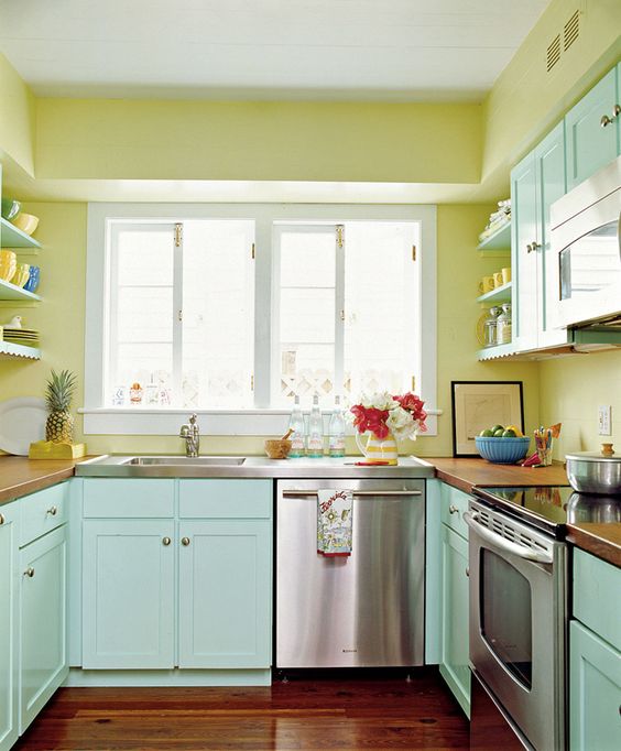 sunny yellow walls and mint painted cabinets make this kitchen warm and inviting