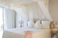 30 feminine bedroom, with a large canopy bed, the frame of which is attached to the ceiling