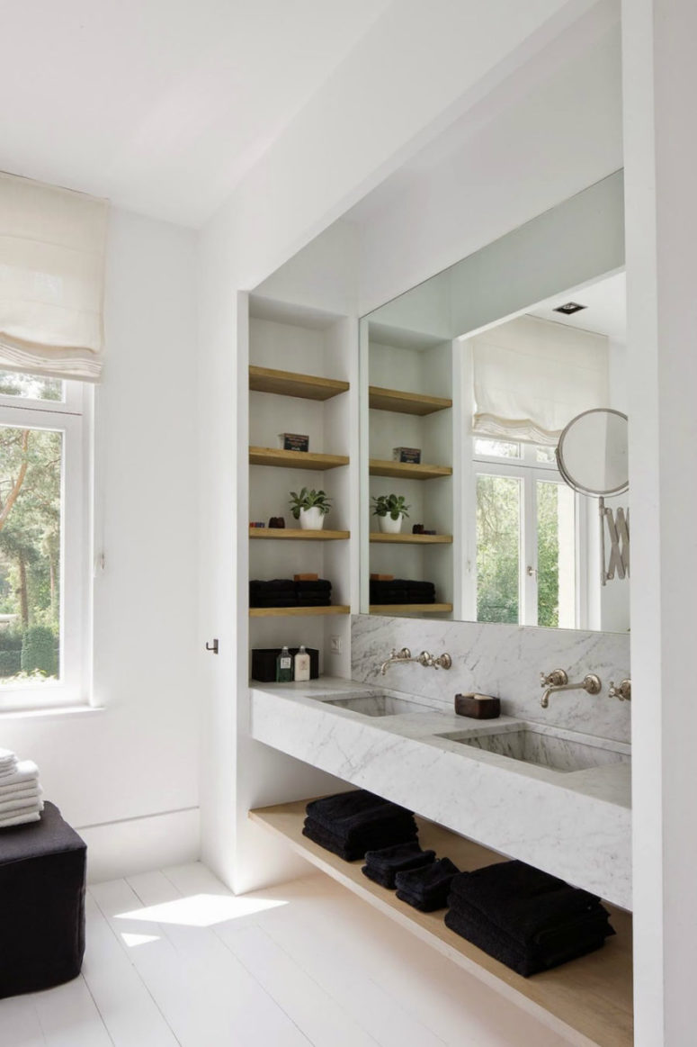 minimalist bathroom with a niche with storage shelves and a mirror