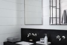 31 black and white industrial bathroom features a honed black marble floating dual vanity accented with built in polished nickel towel bars and square undermount sinks