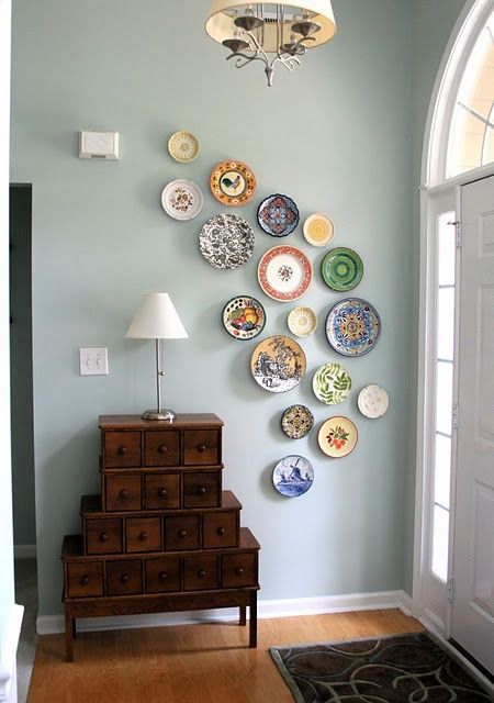 make a wall art of decorative plates that you've brought from various countries