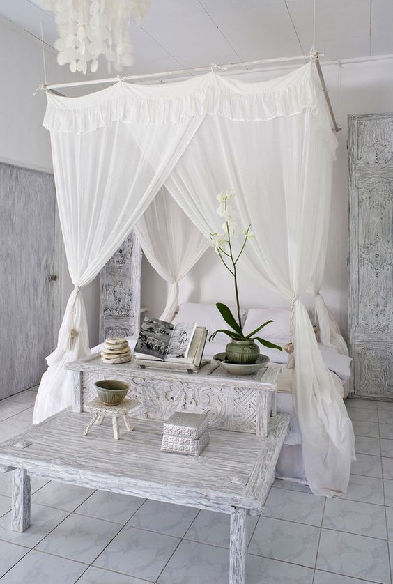 shabby chic and colonial style bedroom decor with a canopy hanging from above