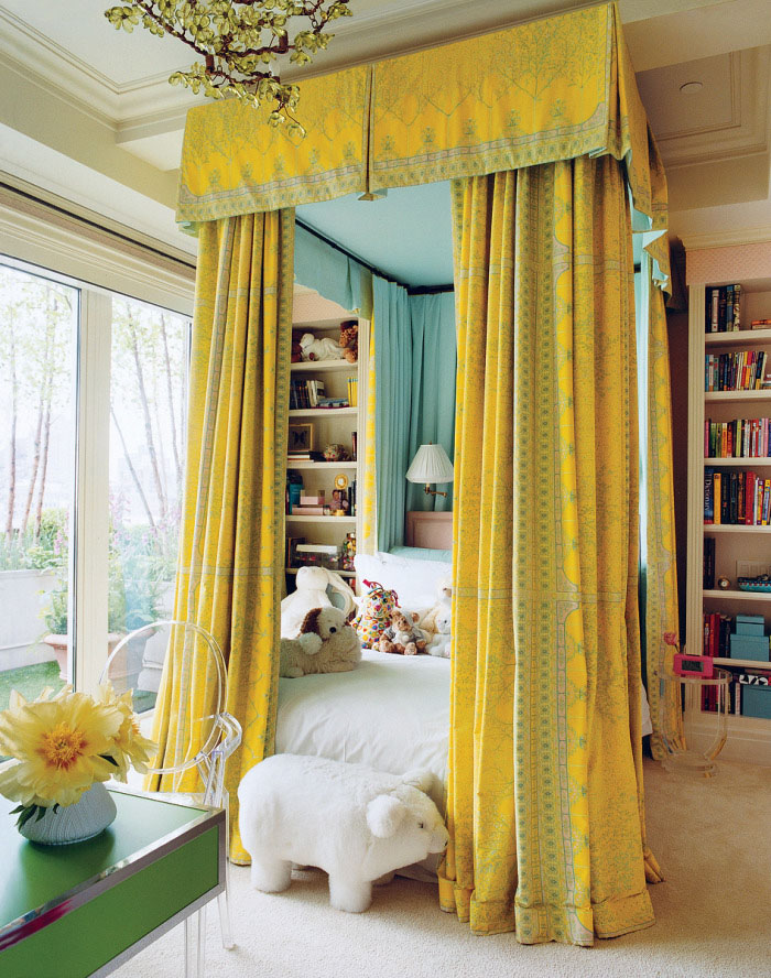 bold canopy bed in a kid's room with sunny yellow curtains
