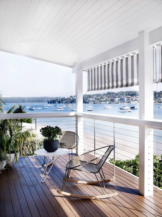 seaside deck with white wood and cable railing to enjoy the views at all levels