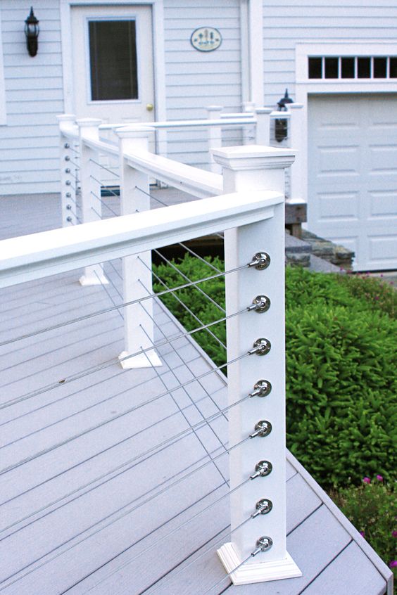 simple white posts and horizontal cable railing for a beachside cottage