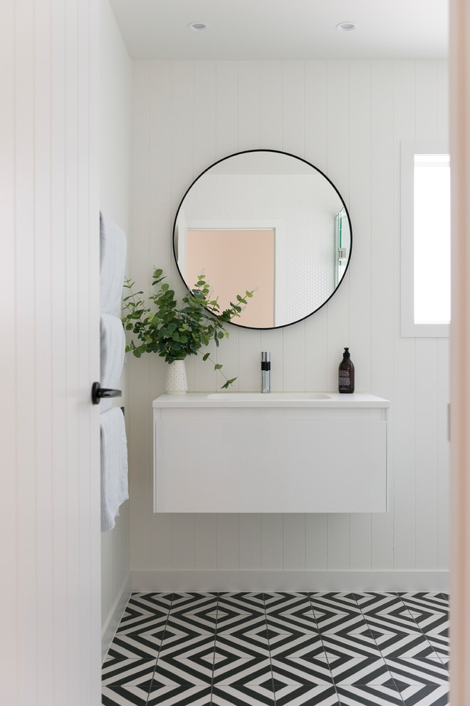 A minimalist glossy white vanity with white countertop is perfect for modern bathrooms. (Style My Abode NZ)