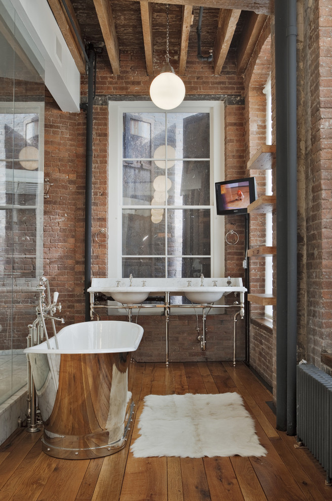 This minimalist metal vanity looks great surrounded by exposed brick walls.  (Kimberly)