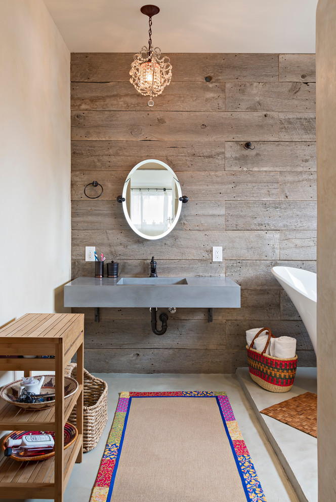 A floating concrete vanity looks great on a rustic wood accent wall. (Dane Cronin Photography)