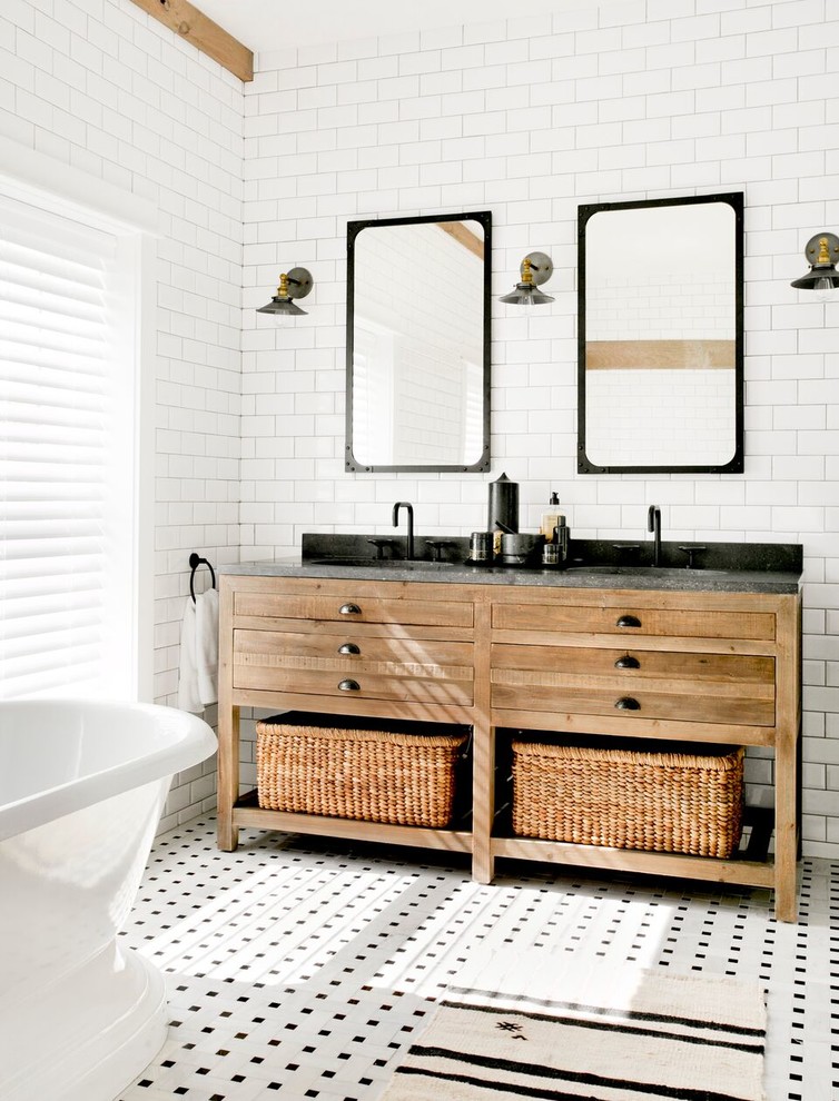 Black countertop looks great on a wooden vanity with lots of drawers and storage baskets. (Timothy Godbold Ltd)