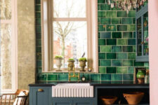 01 This English country kitchen features dark stained wood floors, handmade green tiles and gorgeous crystal chandelier for a glam feel