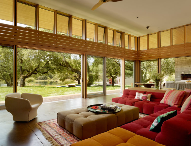 The living room is colorful, and can be opened to outdoors with glass doors