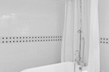 02 a classic clawfoot tub and shower in a timeless black and white bathroom