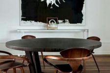 02 this round dark dining table makes a bold statement and everything is centered around it