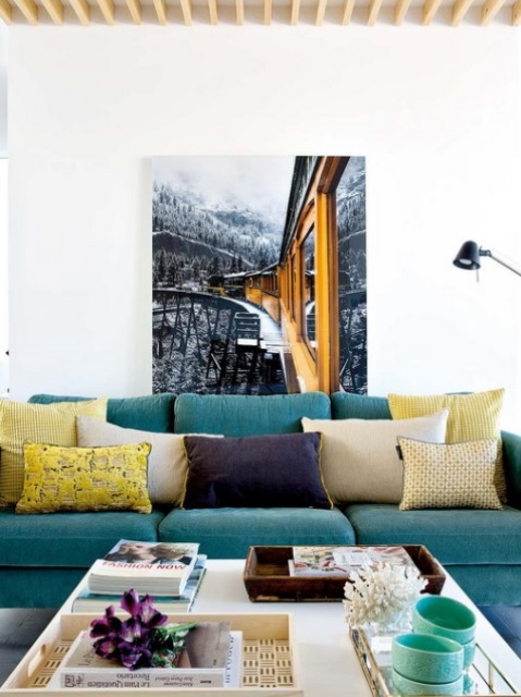 An oversized photo and colorful textiles make the living room eye-catching