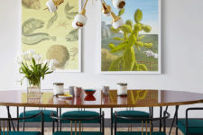 04 Emerald chairs and a mid-century modern chandelier create a style in the dining space, and artworks create a mood