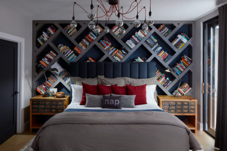 The bedroom features a large herringbone bookshelf, a cool industrial chandelier with red cords and apthecary chest inspired bedside tables