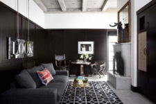 04 There’s a dark room done in black, with a fireplace and an oversized mirror, for a contrast and a soothing ambience