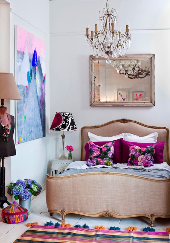 a bold girlish bedroom with a vintage crystal chandlier