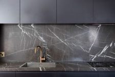 04 minimalist black kitchen cabinets with a black marble backsplash