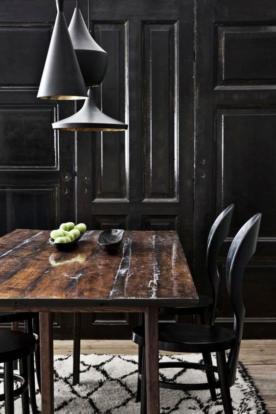 Rough shabby wooden dining table gives this space a harsh look
