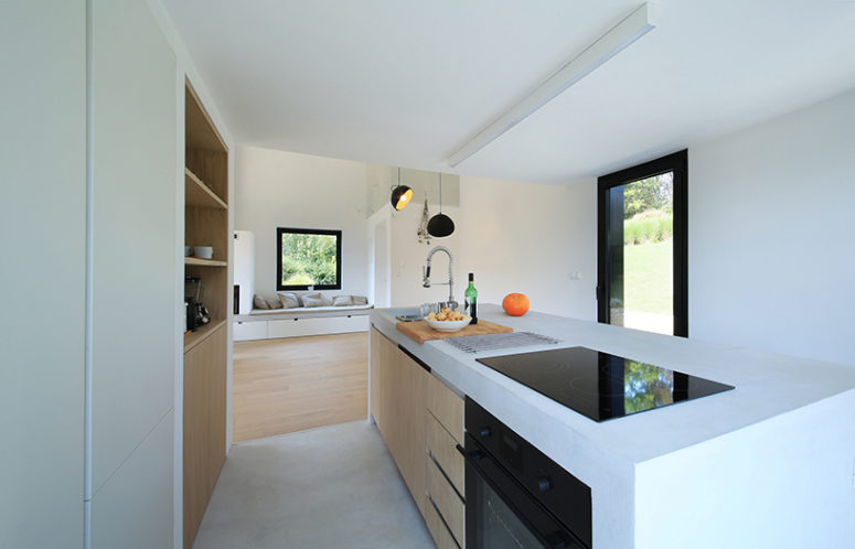 The kitchen is minimalist, with a micro cement topping, like the floor finish, it's very durable