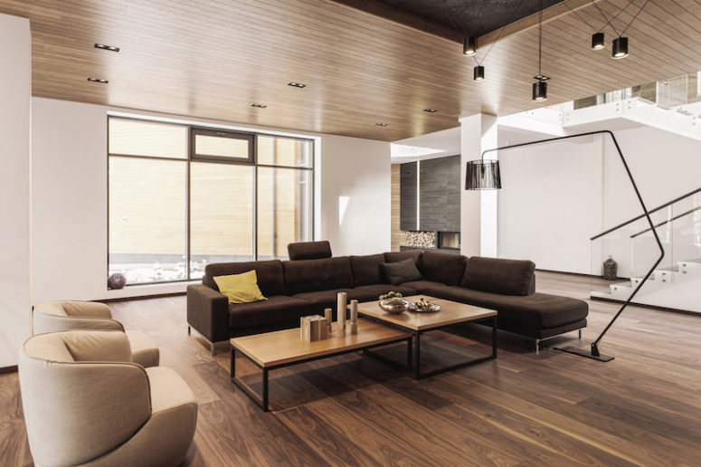 The living room is centered around an L-shaped sectional and a pair of coffee tables