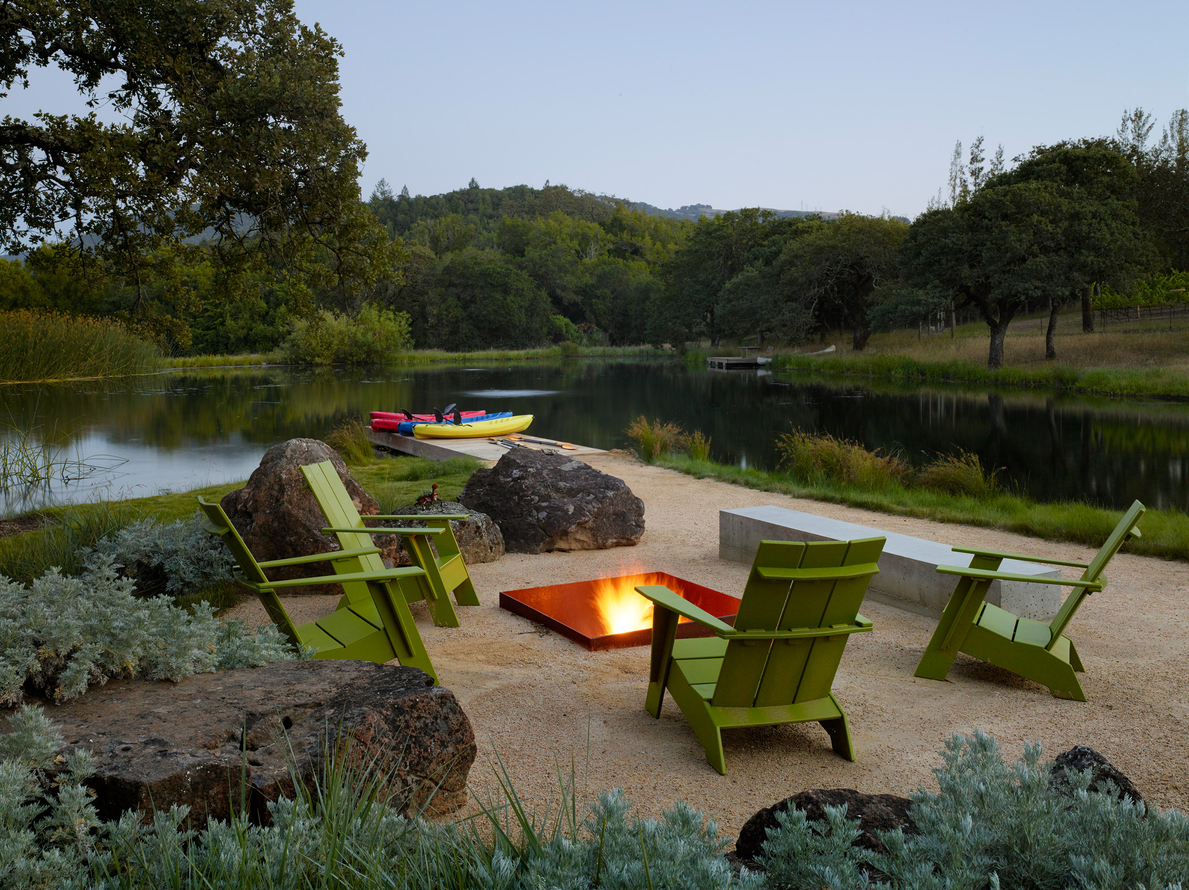 There's a fire pit, lounge chairs and a kayak station