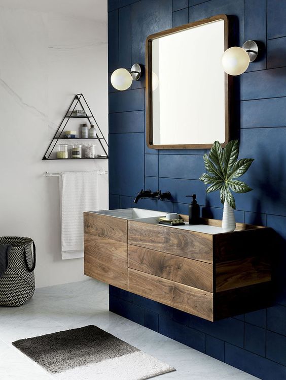 a floating wooden vanity with drawers and a sink