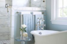 05 a light blue bathroom with a slip clawfoot tub with white legs