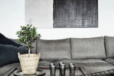 05 upholstered grey sofa with navy pillows and an echoing lamp