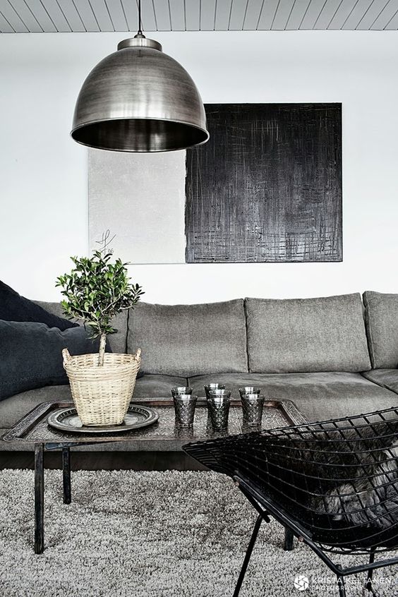 upholstered grey sofa with navy pillows and an echoing lamp