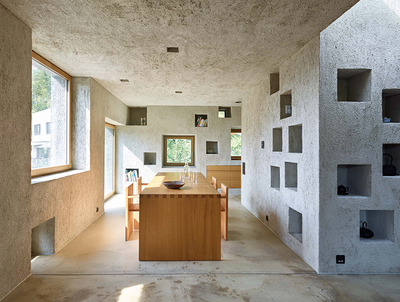 Concrete openings are used for storage inside the house, and lots of windows bring much light in