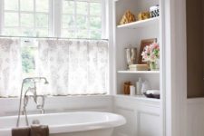 06 a cool freestanding tub in a niche, half curtains for privacy and shelves on each side of the bathtub