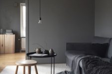 06 a dark grey sofa is a focal point in this moody space
