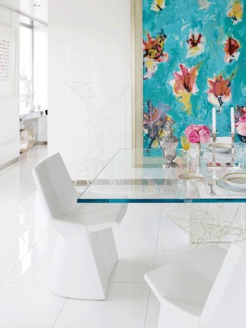 a glass top dining table for modern feminine space and white sculptural chairs