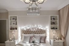 06 a neutral and refined bedroom with a vintage-inspired chandelier with crystals and a fabric lampshade