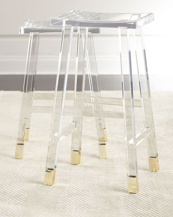 acrylic and brass stools are a chic solution for a modern kitchen