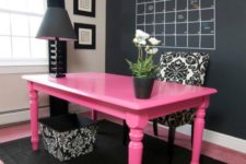 06 bold pink desk in a black home office makes a statement