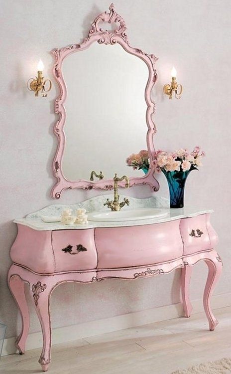 vintage pink bathroom vanity with a matching mirror
