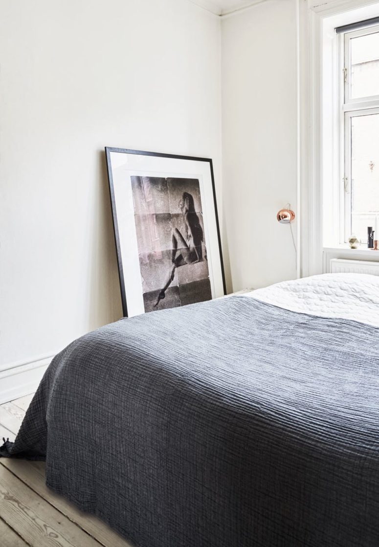A large bed in placed next to the window, an oversized photo adds an artistic feel